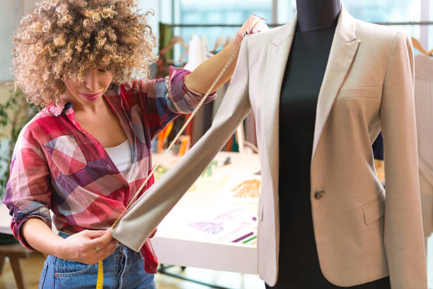 istock Young fashion designer measuring a blazer 465536027