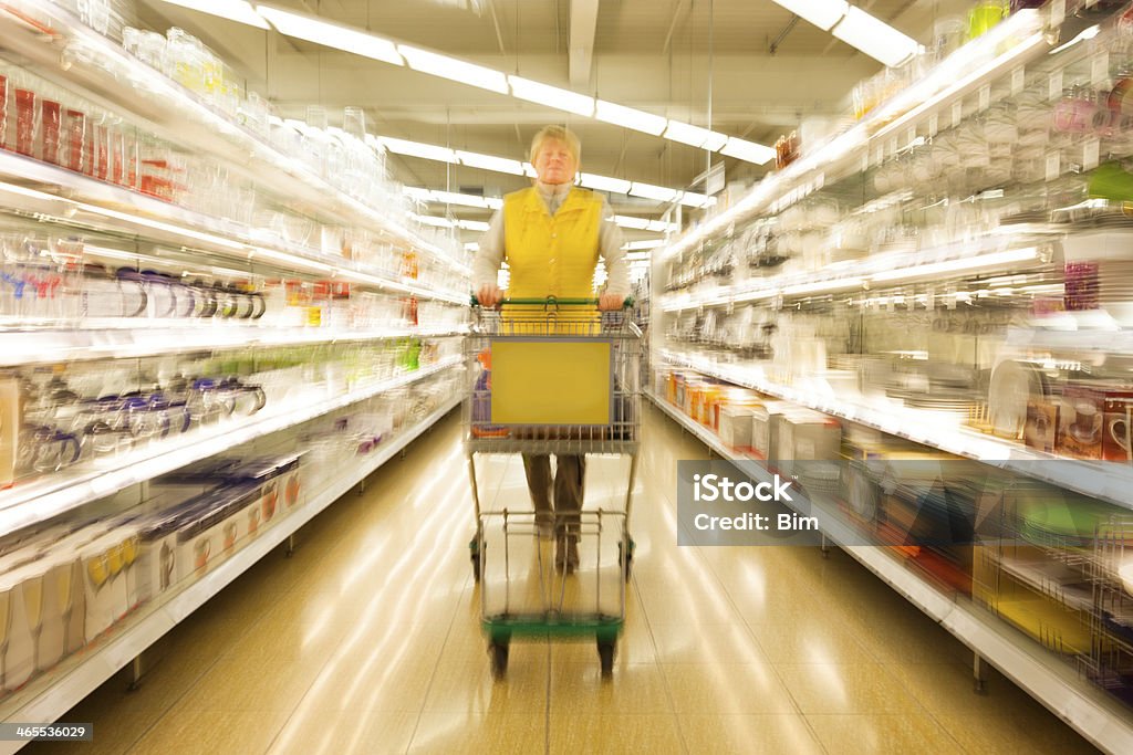 Mature Woman With Shopping Cart  in Supermarket, Motion Blur Mature Woman in Supermarket, Motion Blur Abstract Stock Photo