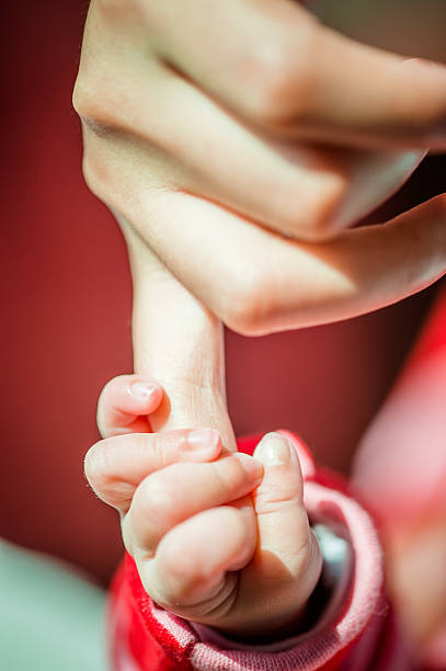 istock Baby Gripping Parents Finger 465536099