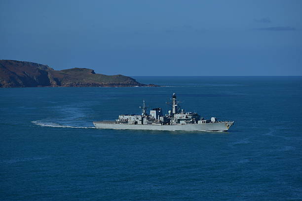 British Royal Navy, Jersey Telephoto image of a Naval frigate patrolling the Channel Islands for over fishing, drug trafficking and military exercises. frigate stock pictures, royalty-free photos & images