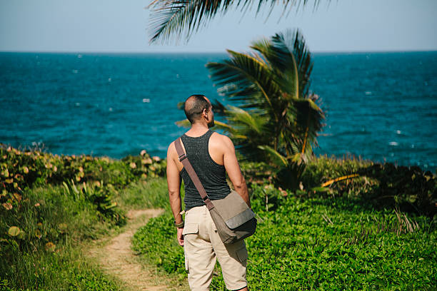 istock Man hiking by sea grass 465537611