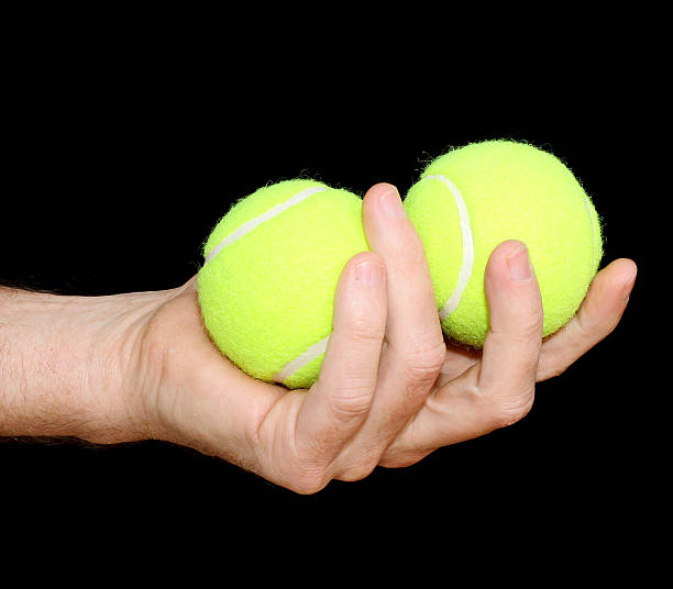 istock Holding Two Tennis Balls 465537810