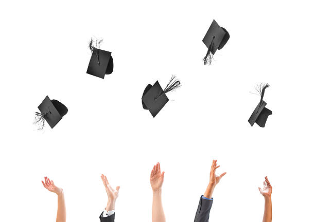 graduation success graduates throw their mortar boards aloft throwing stock pictures, royalty-free photos & images
