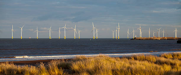 Teesside Offshore Wind Farm, Hartlepool Evening light on the Teesside offshore windfarm from Seaton Carew beach, Hartlepool, England offshore wind farm stock pictures, royalty-free photos & images