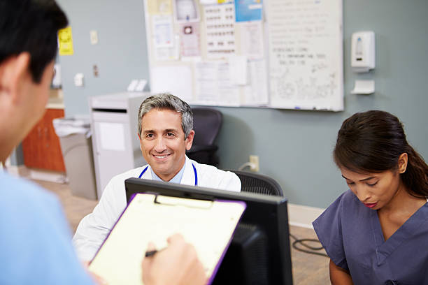 istock Medical Staff Meeting At Nurses Station 465538535