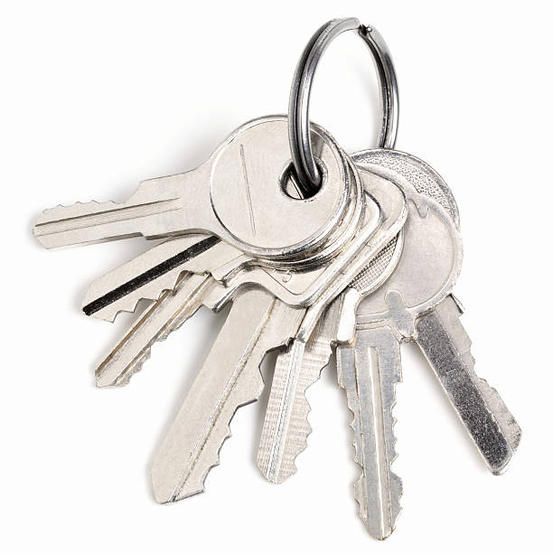 Silver keys isolated on white background Bunch of keys on a white background key ring stock pictures, royalty-free photos & images