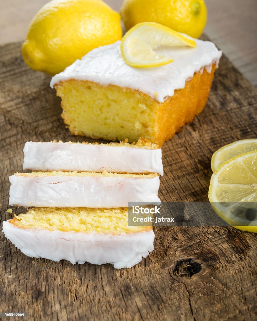 Sliced lemon pound cake with white icing Sliced lemon pound cake with white icing and lemons Pound Cake Stock Photo