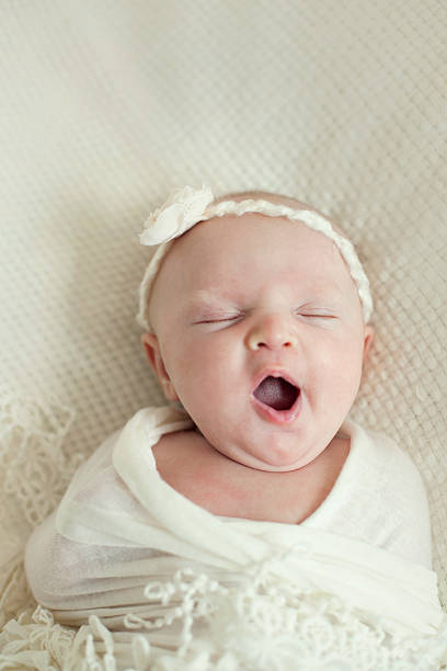istock Sleeping newborn yawn wrapped in lace 465543853