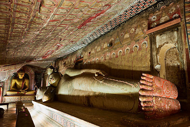 Buddha statue inside Dambulla cave temple, Sri Lanka Buddha statue inside Dambulla cave temple, Sri Lanka. Dambulla cave temple also known as the Golden Temple of Dambulla is a World  Heritage Site in Sri Lanka, situated in the central part of the country. This site is situated 148 km east of Colombo and 72 km  north of Kandy. It is the largest and best-preserved cave temple complex in Sri Lanka. There are more than 80 documented caves in  the surrounding area. Major attractions are spread over 5 caves, which contain statues and paintings. These paintings and statues  are related to Lord Buddha and his life. There are total of 153 Buddha statues, 3 statues of Sri Lankan kings and 4 statues of  gods and goddesses.http://bem.2be.pl/IS/tea_plantations_380.jpg dambulla stock pictures, royalty-free photos & images