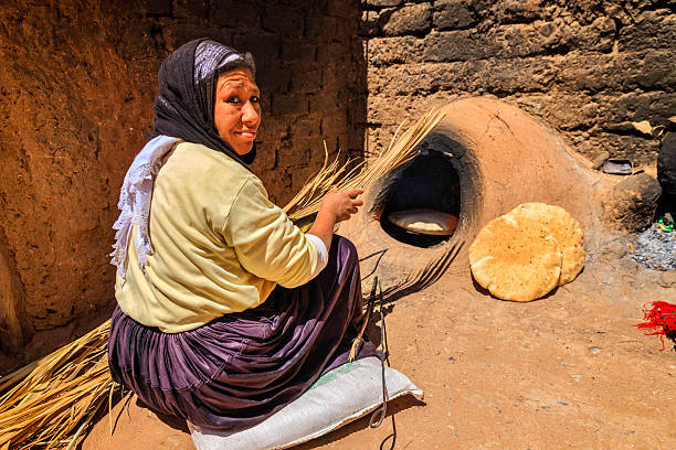 istock Moroccan woman baking bread - khubz 465547535