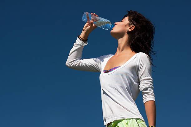 istock Young tanned athlete drinking water 465548849
