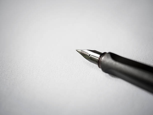 istock Pen and paper on background Black and white 465549548