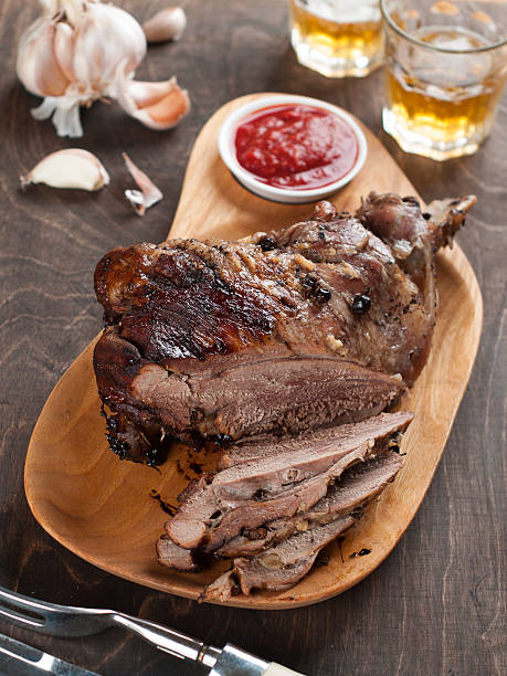 Roasted leg meat served with whiskey, sauce and garlic stock photo