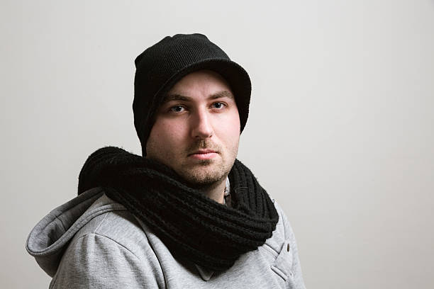 istock young man waering winter scarf and hat portrait 465552193