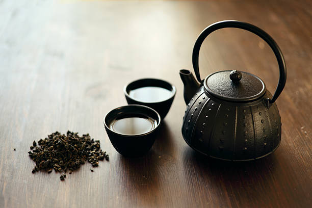 Image of traditional eastern teapot and teacups on wooden desk stock photo