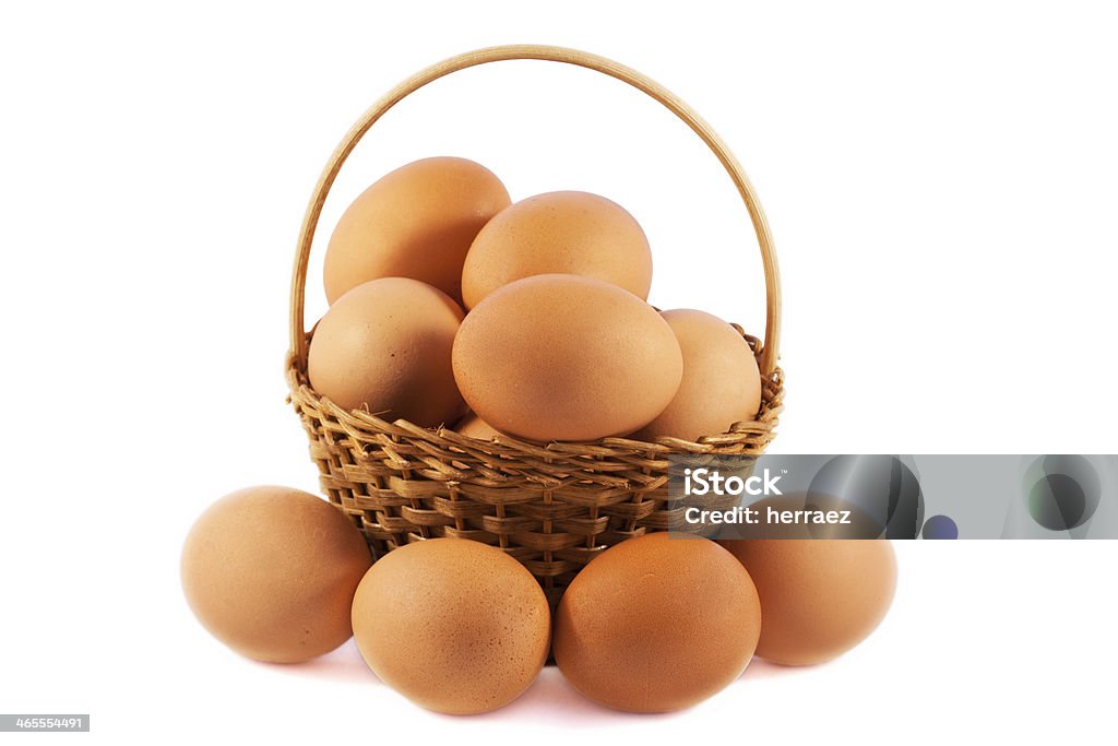 Eggs in a basket over white isolated background Animal Stock Photo