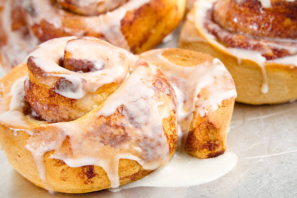 istock Cinnamon rolls with sugar sauce dripping off of them 465554639