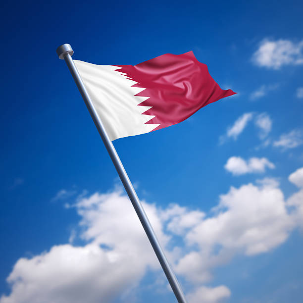 istock Flag of Qatar against blue sky 465555215