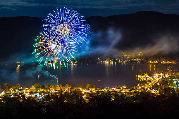 Fireworks explode over Lake George Village, NY in the Adirondack State Park at night as seen from Prospect Mountain.
