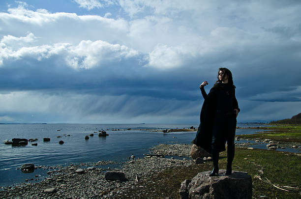 istock girl on a rocky shore 465556496