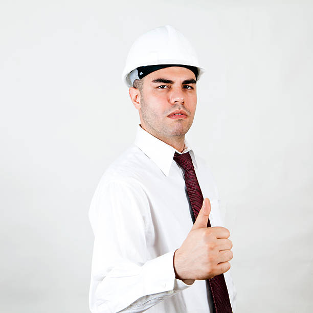 istock Successful engineer with thumbs up gesture isolated on white background 465560845