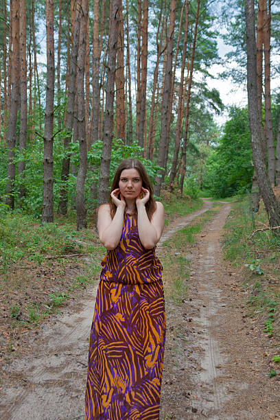 istock Pretty young woman standing on the forest road 465561195