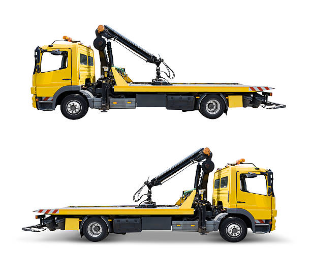 Yellow tow truck. Isolated on white with clipping path Yellow truck truck, isolated on white, with clipping path. The shadow of the lower version is not icluded in the area surround by clipping path. adac stock pictures, royalty-free photos & images