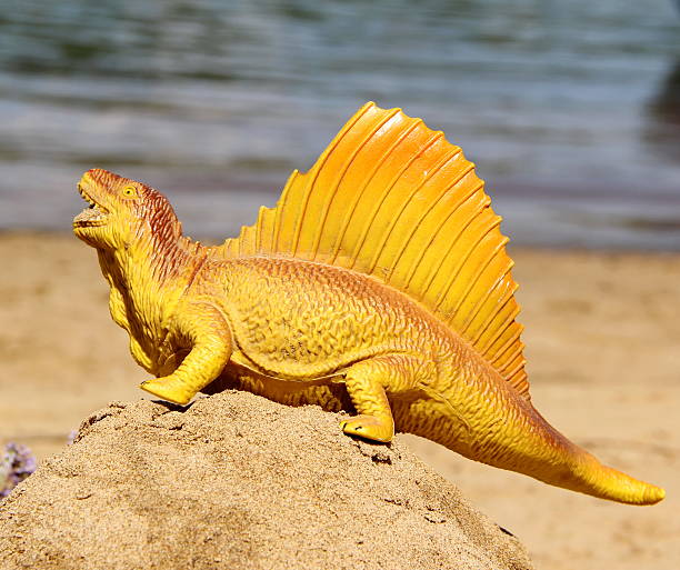 istock Dinosaur toy on a hill made of sand 465571539