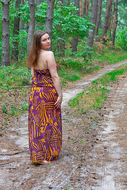 istock Pretty young woman standing on the forest road 465571693