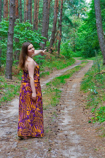 istock Pretty young woman standing on the forest road 465571709