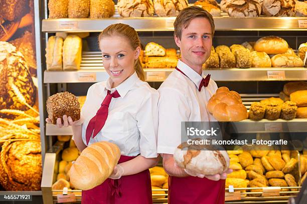 Bakers Presenting Loafs Of Bread In A Bakery Stock Photo - Download Image Now - Adult, Baguette, Baked Pastry Item