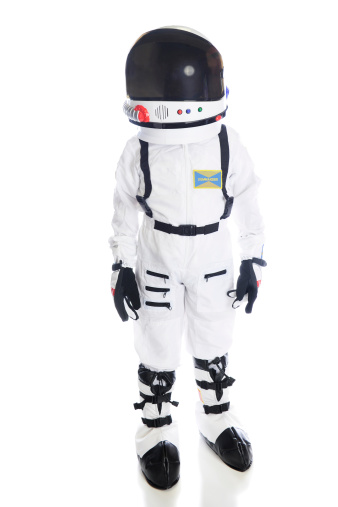 A young astronaut in full uniform including a closed helmet.  (The child's face is hidden by the helmet visor.)  On a white background.