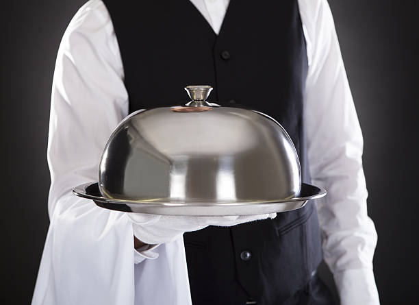 istock A waiter holding a tray with lid 465579725