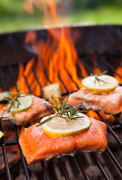 Three grilled salmon fillets on a BBQ