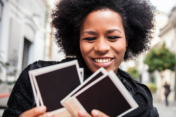 Young woman browses instant camera photo frames