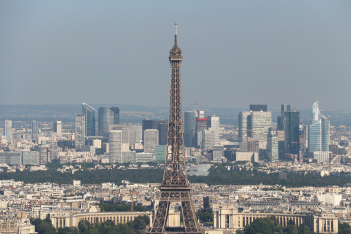 Aerial view through Eiffel Tower to La Défense district in Paris, France.