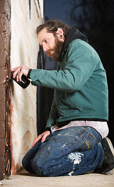 istock Kneeling Man Spray Painting 465585397