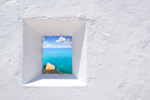 istock Mediterranean Ibiza seascape through window in white wall 465596866