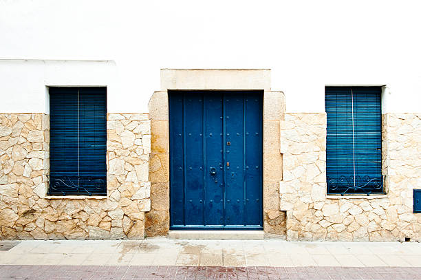istock Blue window and a door on the wiht wall 465600313