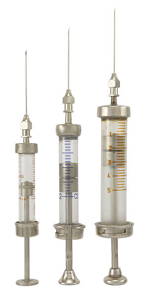 Three old different size syringe with needle isolated on white.