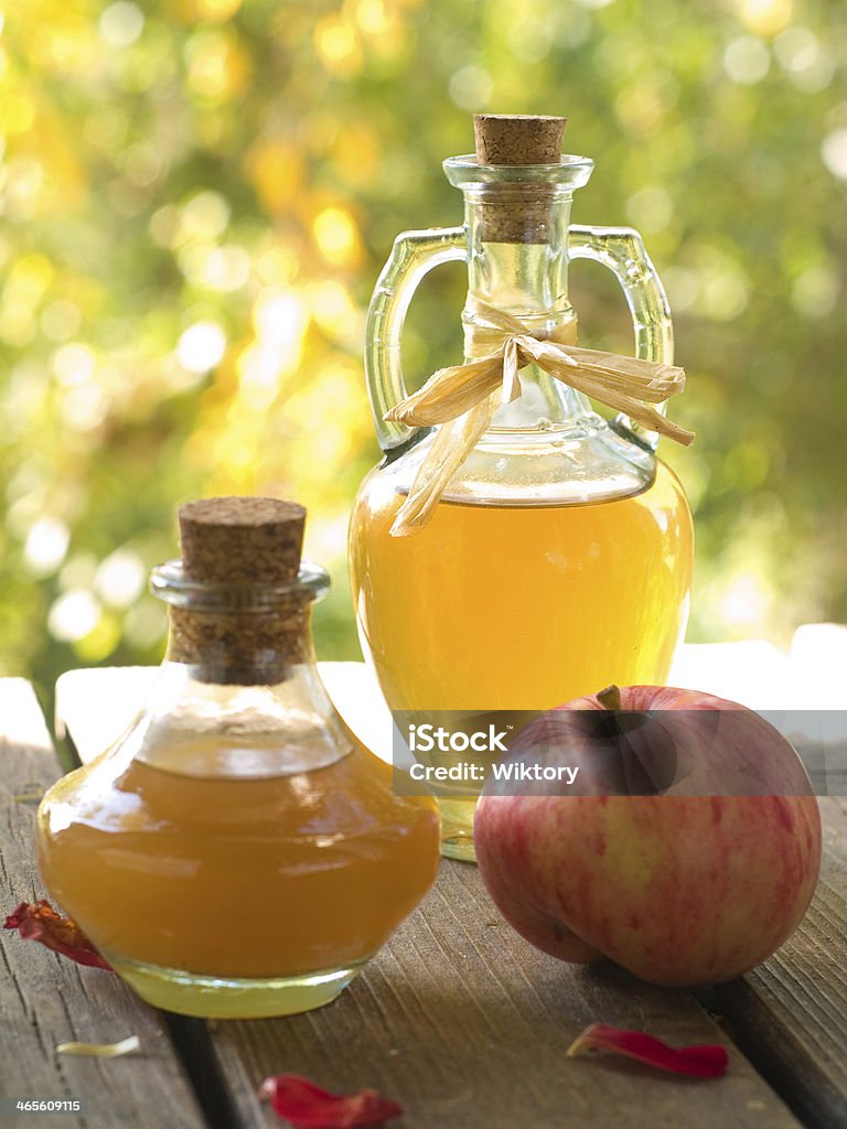 Apple cider vinegar Apple cider vinegar in glass bottle, selective focus Acid Stock Photo