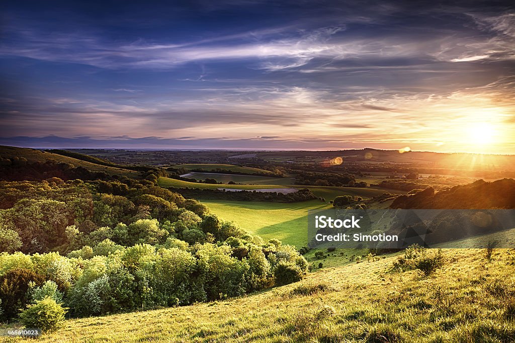 Winchester hill sunset Winchester hill sunset across folding farmland and trees Rural Scene Stock Photo