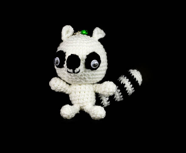 istock handmade crochet monkey and raccoon doll on black background 465611417