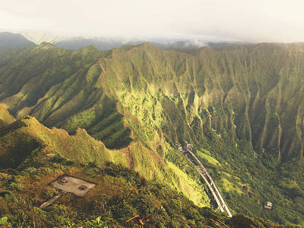A photo taken with an Iphone5 from the top of the Ko'olau Mountain Range on Oahu in the morning light with H3 Highway far below.