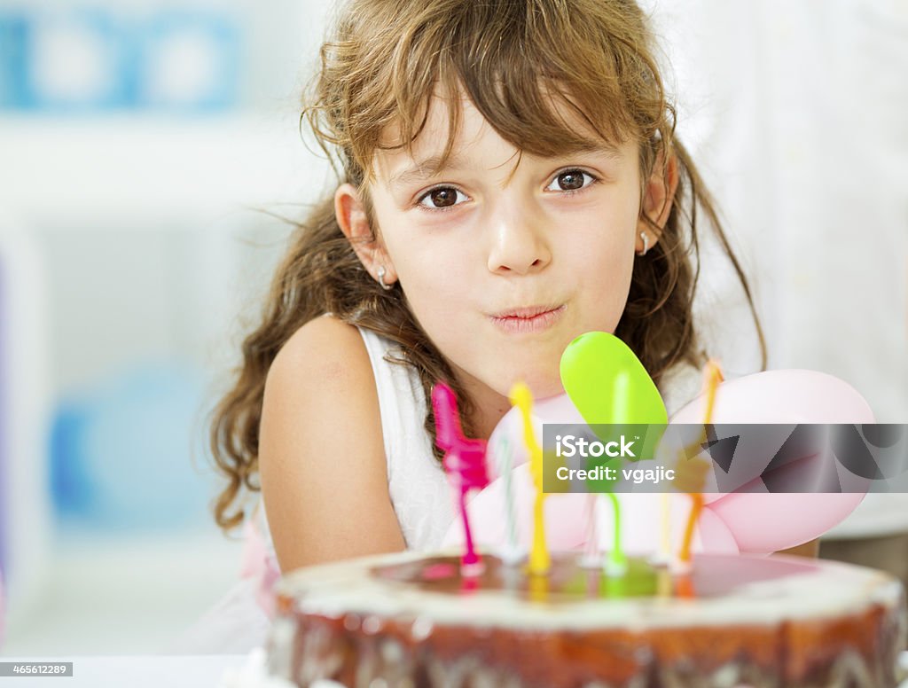 Allegra bambina soffiare le candele di compleanno. - Foto stock royalty-free di 6-7 anni