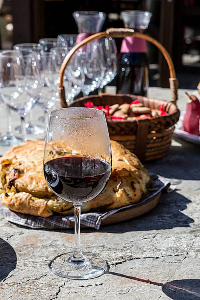 istock Glass of red wine with food on table 465612844