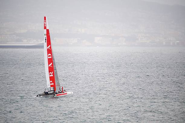 Sailing boat on the Lake Leman (Switzerland) during a cold afternoon. Behind the lake, the Swiss Alps with a bit of snow on the top.