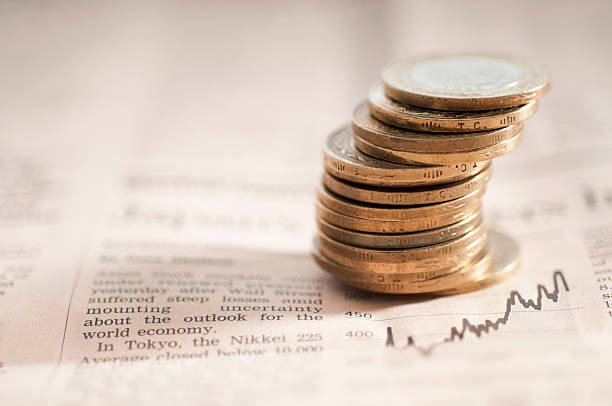 istock Newspaper financial section with coins 465617473