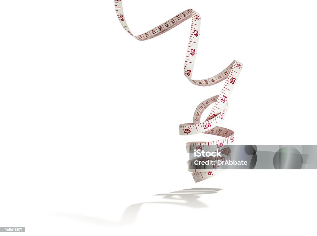 Tape Measure on White with Shadow Measuring tape coiled and floating on a white background. Aspirations Stock Photo