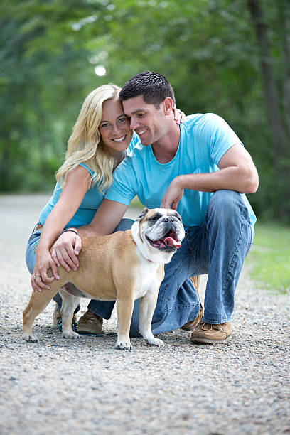 istock happy couple with dog 465618889